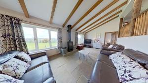 a living room with a couch and a large window at The Barn. in Carmarthen