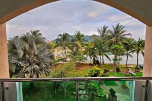 a view from a window of a resort with palm trees at Laguna 1, Marina Island by TZ Homestay in Lumut