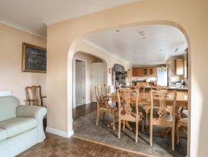 a kitchen and dining room with a table and chairs at Glan Gors in Llandyfrydog