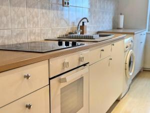a kitchen with a sink and a stove top oven at Stadion Apartment für 4 Personen in Kassel