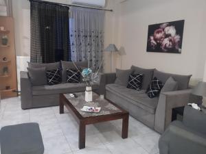 a living room with two couches and a coffee table at Modern Apartment Chania Center in Chania