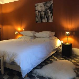 a bedroom with a large white bed with two pillows at B&B Vigne Vierge in Aigne