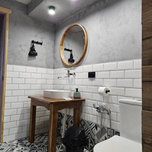 a bathroom with a sink and a mirror on the wall at Садиба "333" in Yaremche