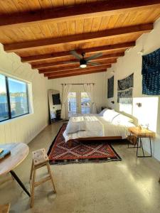 a bedroom with a bed and a wooden ceiling at Blue Sunday, Desert House w/ hot tub -Joshua Tree in Joshua Tree