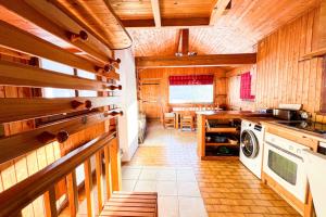a kitchen with wooden walls and a washer and dryer at Snowflake cottage with garden in Chamonix