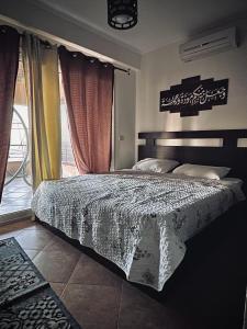 a bedroom with a bed and a window at Telal elsokhna families in Ain Sokhna