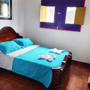 Llit o llits en una habitació de Hostal Palmas De Cocora