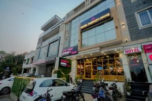 a car parked in front of a hotel with parked motorcycles at Hotel Pinkcity Prime & Chicago View Cafe in Jaipur