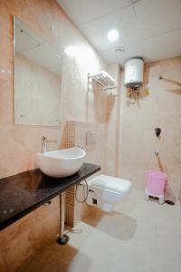 a bathroom with a sink and a toilet at Hotel Pinkcity Prime & Chicago View Cafe in Jaipur