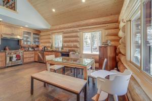 a kitchen with wooden cabinets and a table and chairs at Truckee Cabin with Patio Less Than 1 Mi to Donner Lake! in Truckee