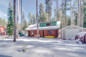 a log cabin in the snow with a garage at Truckee Cabin with Patio Less Than 1 Mi to Donner Lake! in Truckee