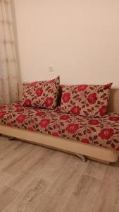 a bed with two pillows on it in a room at 3-х комнатная квартира в Павлодаре in Pavlodar