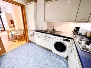 uma cozinha com um lavatório e uma máquina de lavar roupa em Excellent Entire Apartment Between St Pauls Cathedral and Covent Garden em Londres