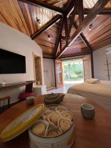 a room with a table with a bowl of food on it at Pousada Vila Margarida in Chapada dos Guimarães