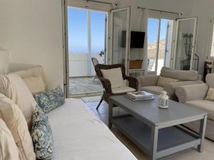 a living room with a couch and a table at Luxurious Villa on the famous glp cat sanctuary in Kinion