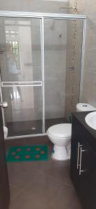 a bathroom with a shower and a toilet and a sink at Casa descanso Mariquita in Mariquita +13 photos