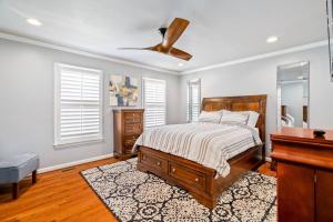 a bedroom with a bed and a ceiling fan at Fantastic Cottage with big backyard near the city in Greensboro