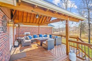 a patio with a couch and chairs on a wooden deck at Fantastic Cottage with big backyard near the city in Greensboro