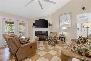 a living room with a couch and a fireplace at Fantastic Cottage with big backyard near the city in Greensboro