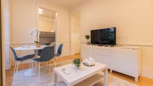 a living room with a table and a tv at 2BDR Alcântara Nest by LovelyStay in Lisbon