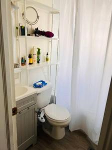 a white bathroom with a toilet and a sink at 10 min Downtown-3 min Irvington in Indianapolis