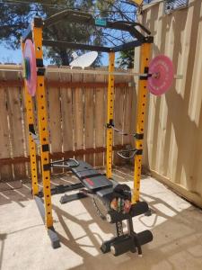 a gym in a backyard next to a fence at TinyHome at the Sanctuary in Lakeside
