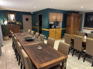 a dining room with a wooden table and chairs at La Ferme de Maraval in Cénac-et-Saint-Julien