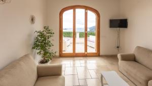 a living room with two couches and a large window at Casa Vacanze Agape in Positano