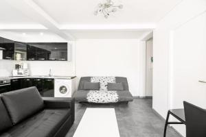 a living room with a couch and a table at Appartement Montparnasse in Paris +4 photos