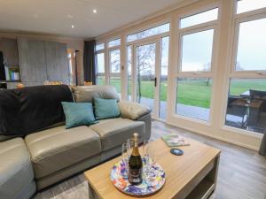 a living room with a couch and a table at Holmside in Market Drayton