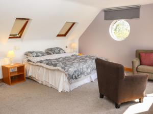 a bedroom with a bed and a chair at Seafield in Ballymoney Cross Roads