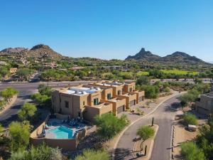 an aerial view of a building with mountains in the background at Residence 1: The Villas At Troon North in Scottsdale