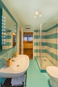 ein Bad mit einem Waschbecken und einer Dusche in der Unterkunft Apartman Škor in Komiža
