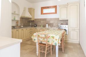 a kitchen with a table with chairs and a stove at Casa Vacanze Agape in Positano