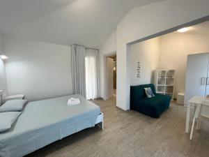 una camera con un letto blu e una sedia blu di Case Vacanze "Bianco Mare" a Porto Pino