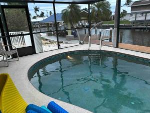 a large swimming pool with a view of the water at Boaters Paradise in St James City in Saint James City