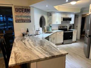 a kitchen with a large marble counter top at Boaters Paradise in St James City in Saint James City