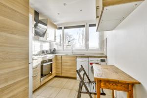 - une petite cuisine avec une table et une table en bois dans l'établissement Nice apartment, 15min from Paris, à Antony