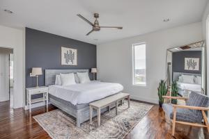 a bedroom with a large bed and a mirror at Whiskey House with Rooftop Golf, City views! 8min to Downtown! Sleeps 9! in Nashville
