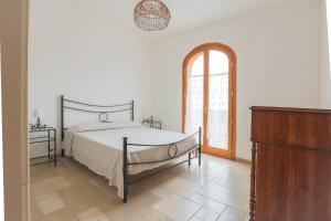 a bedroom with a large bed and a window at Casa Vacanze Agape in Positano