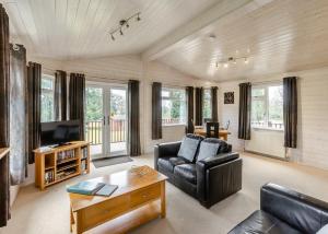 a living room with a couch and a coffee table at Ruby Country Lodges in Beaworthy