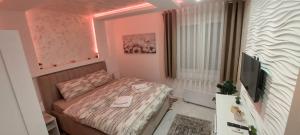 Voodi või voodid majutusasutuse GOLD APARTMANI toas