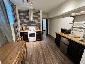 a kitchen with a sink and a stove top oven at Dt 1 Br 1bath Cozy Suite 8 Min Walk To Arena in Edmonton