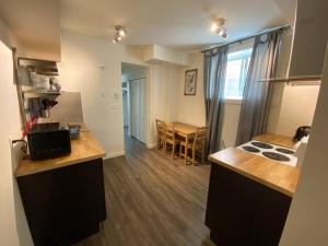a kitchen with a stove and a counter top at Dt 1 Br 1bath Cozy Suite 8 Min Walk To Arena in Edmonton