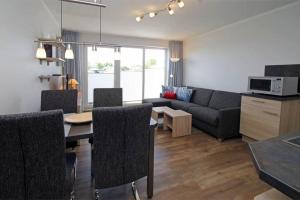 a living room with a couch and a table at Yachthafenresidenz-Wohnung-9108-882 in Kühlungsborn
