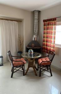 a living room with a table and two chairs and a stove at Rodopi Apartment in Skala +18 photos