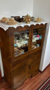 a wooden cabinet with two bells on top of it at Hostel - F in Gjakove