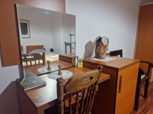 a dining room with a table and a mirror at Hostel - F in Gjakove