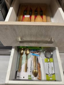 a drawer filled with utensils and spoons at Modern 1BR in Dubai South Mag5 with all utilities in Dubai