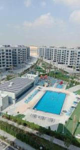 an overhead view of a swimming pool in a city at Modern 1BR in Dubai South Mag5 with all utilities in Dubai